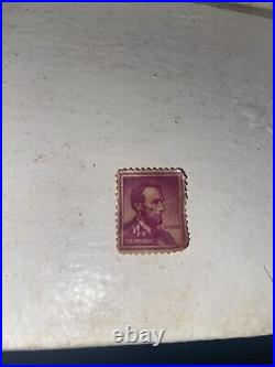 Abraham Lincoln 4 cent stamp purple color, slightly used