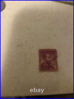 Abraham Lincoln 4 cent stamp purple color, slightly used